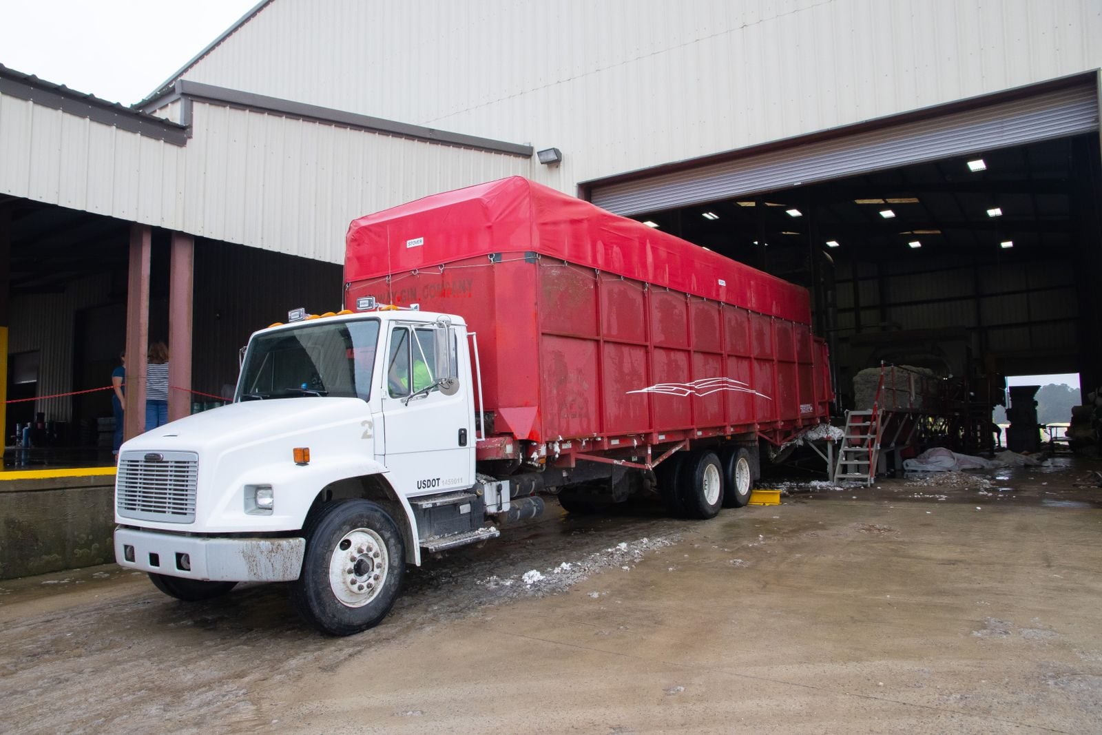 Freight truck positioned at an industrial warehouse loading dock