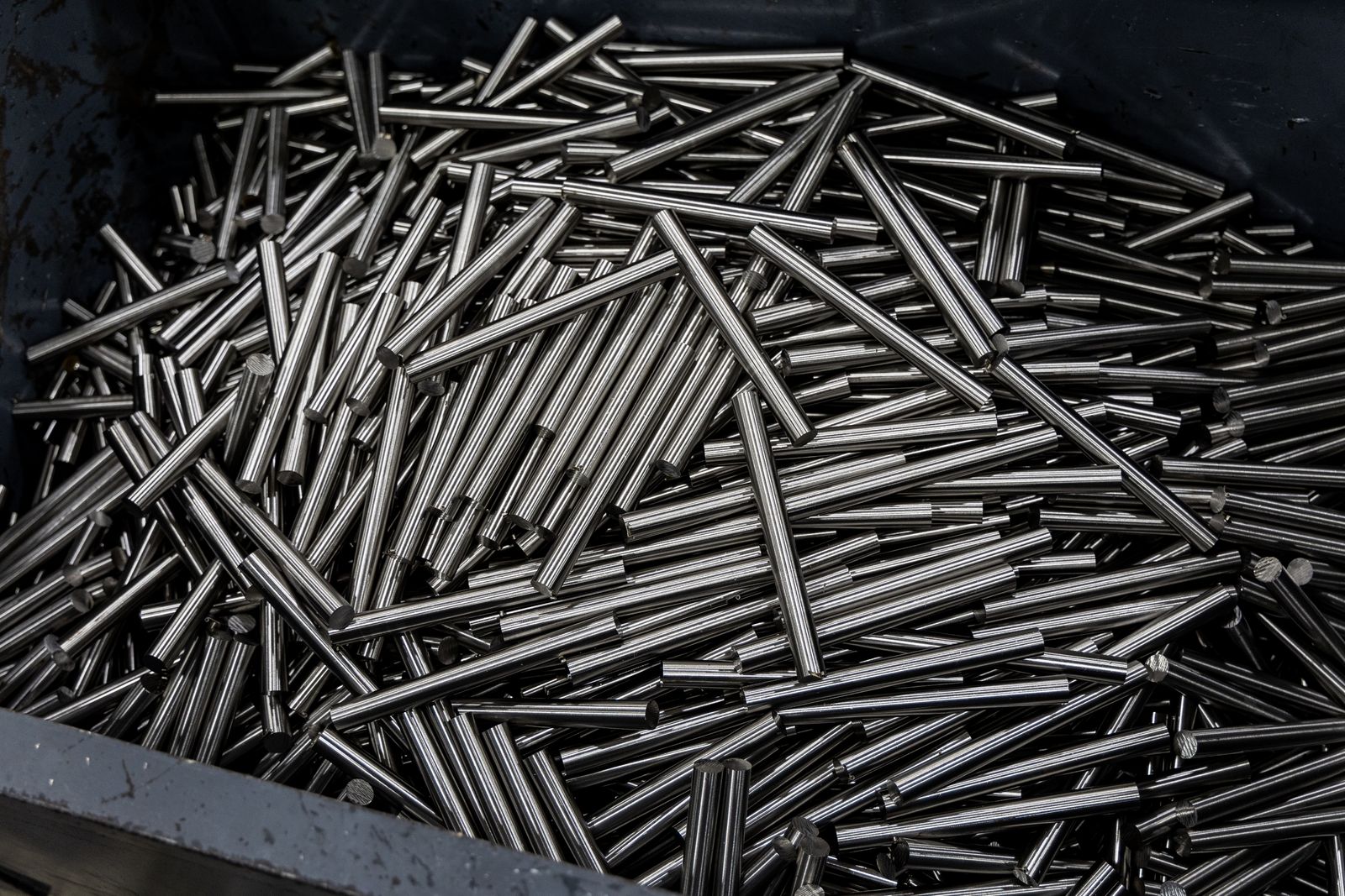 Cut metal rods collected in an industrial bin